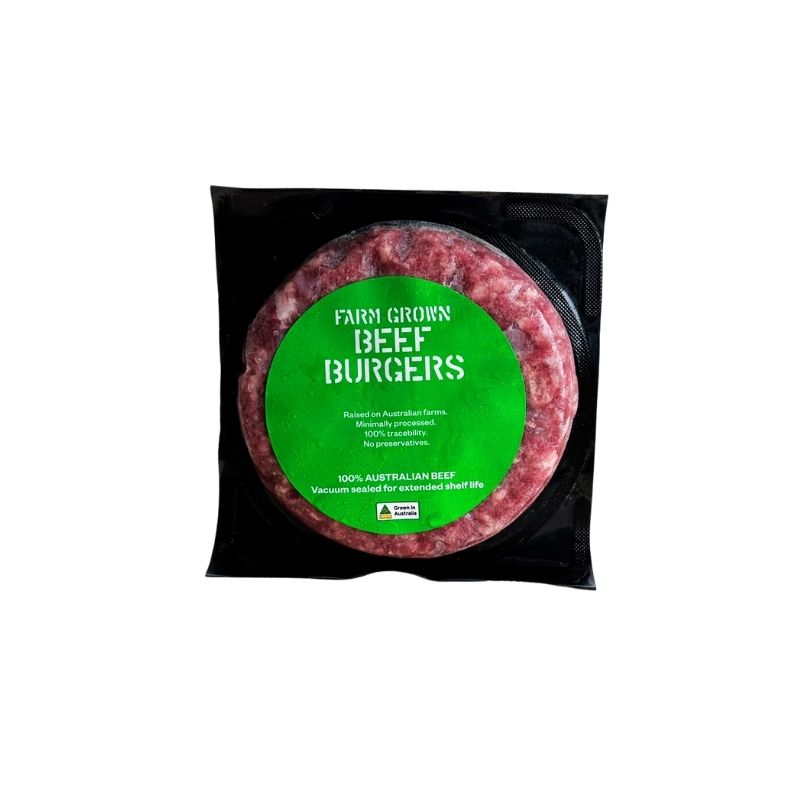 Australian AMG Grass Fed Burger Patty - 150g in a black plastic tray with a large green circular label reading 'FARM GROWN BEEF BURGERS' on a white background.