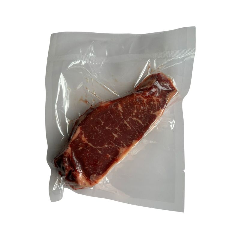Vacuum-sealed Australian AMG Grass Fed  Steer Striploin on a white background