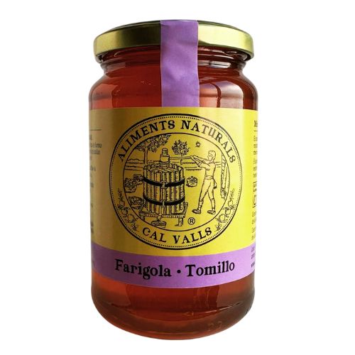 Jar of Cal Valls Thyme Honey with a yellow label and gold lid on a white background