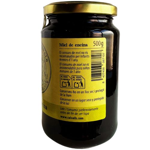 Jar of Cal Valls Wild Oak Honey with a gold lid and a yellow label on a white background
