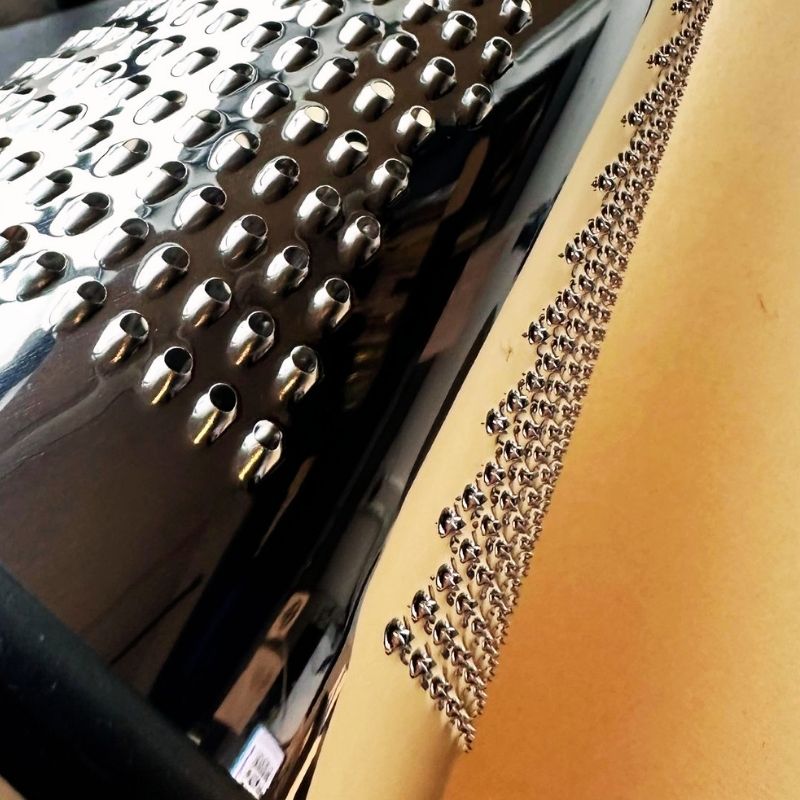 Close-up of a Conical Stainless Steel Grater on a wooden surface