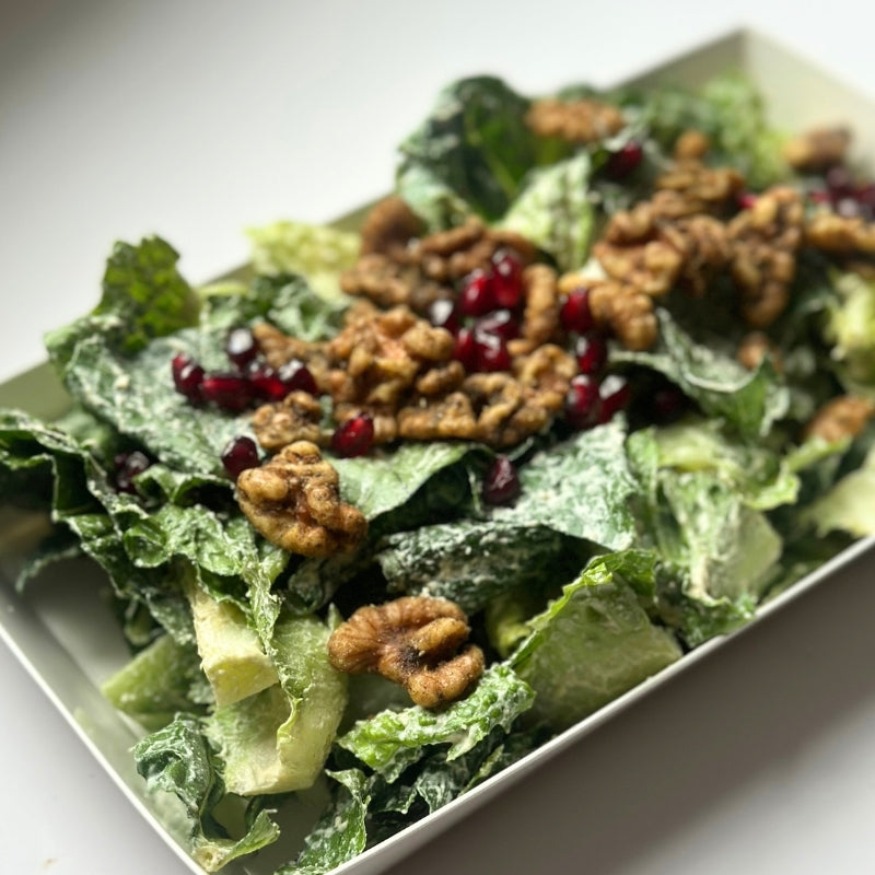 A close up video of Crispy Romaine Salad with Pomegranate, House Cashew Sour Cream & Garlic-Herb Sprouted Walnuts