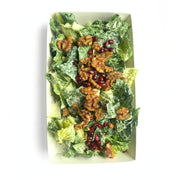 A top-down view of a Crispy Romaine Salad with Pomegranate, House Cashew Sour Cream & Garlic-Herb Sprouted Walnuts  in a white rectangular container, topped with walnuts and pomegranate seeds on a white background.
 (380g | Serves 4-6)
Foodcraft Online Store 