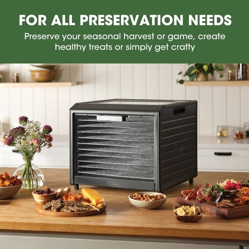Excalibur 10 Tray Performance Digital Dehydrator, in Stainless Steel - DH10SSSS13 shown in a kitchen setting with prepared foods arranged around it. A green banner at the top reads, 'FOR ALL PRESERVATION NEEDS Preserve your seasonal harvest or game, create healthy treats or simply get crafty.