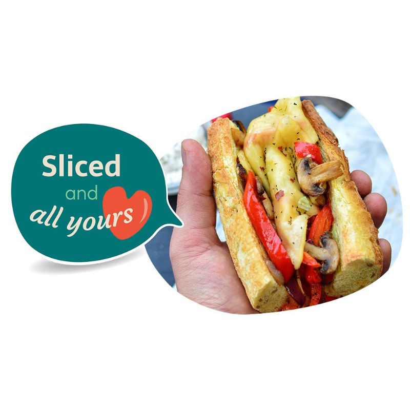 Hand holding a sub sandwich with GREEN VIE Vegan Gouda Flavour Slices, vegetables and a speech bubble saying 'Sliced and all yours' on a white background.