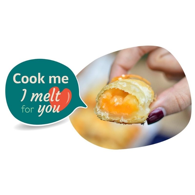 Hand holding a melted cheese pastry with a speech bubble saying 'Cook me I melt for you' on a white background.