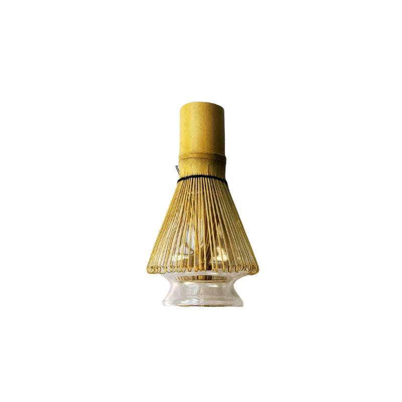 Bamboo whisk with a glass chasen tate on a white background