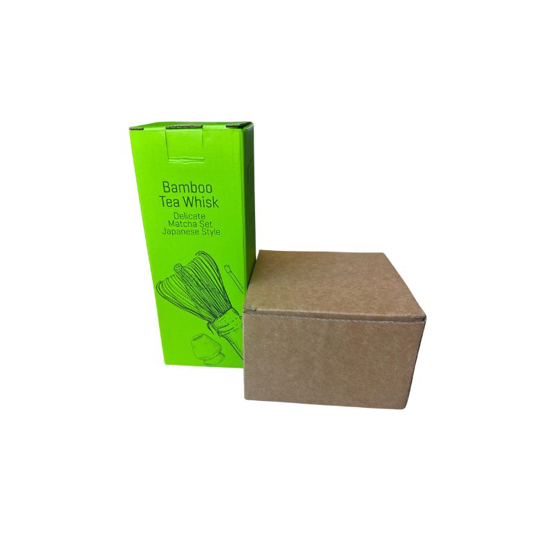 Green box with bamboo tea whisk illustration and brown packaging on a white background