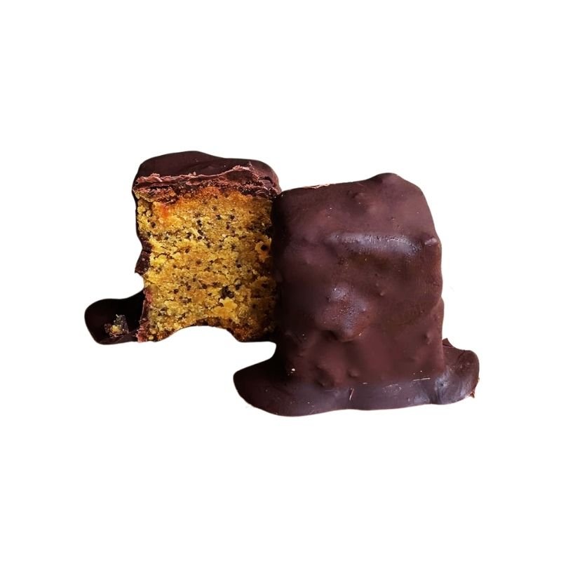 A chocolate-covered  Gluten Free Keto Dark Chocolate Coated Lemon Poppy Seed Cake piece shown on a plain white background, with one half cut open to reveal a golden-brown crumb interior.
