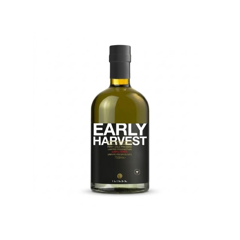 A bottle of ILIADA Early Harvest Extra Virgin Olive Oil Unfiltered - 500ml against a plain white background. The bottle is made of dark glass showing the golden-amber liquid inside, with a black label featuring bold white text and a black cap.