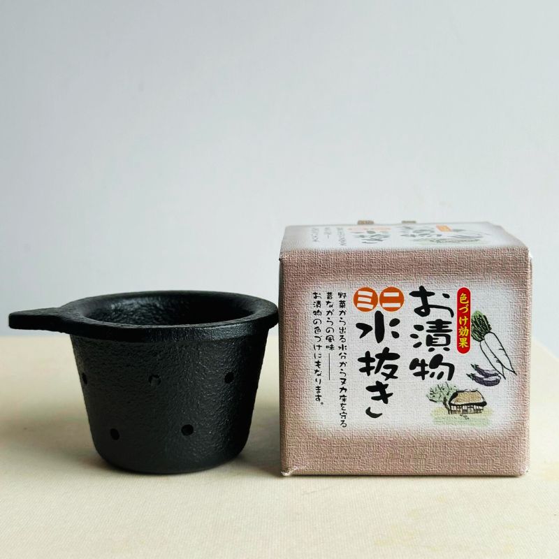 Ikenaga Iron Works Nanbu Ironware Water Drainer & Iron Supplement for Nukazuke - Mini and its packaging with Japanese text on a light background