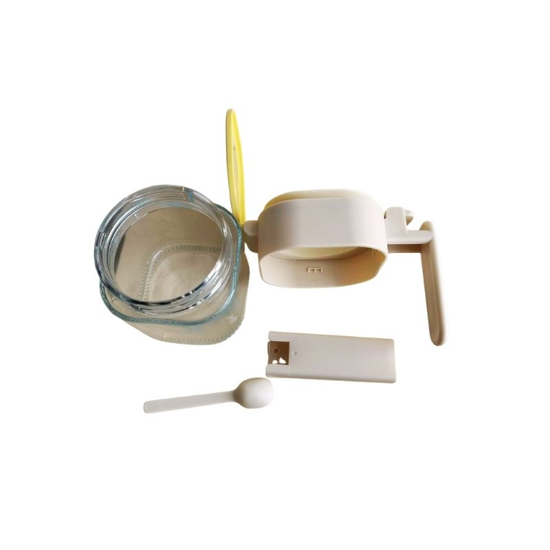 Japanese-Style Airtight Condiment Glass Pot - 300ml' parts, glass jar with beige lid, white spoon, and white spoon case on a white background