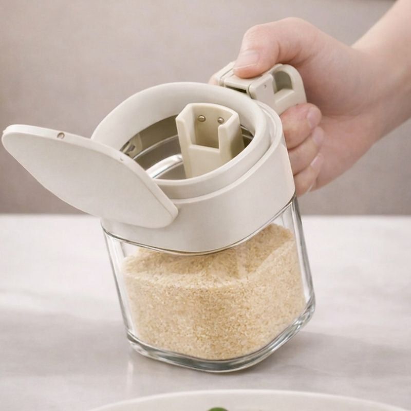 Hand holding Japanese-Style Airtight Condiment Glass Pot - 300ml filled with sugar on a light surface.