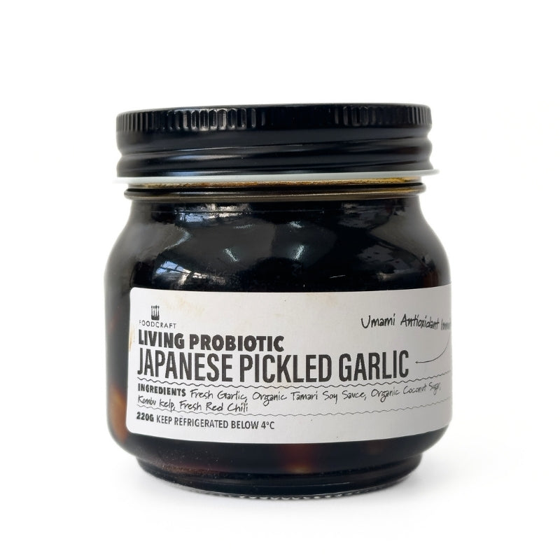 Jar of Living Probiotic Japanese Pickled Garlic on a white background