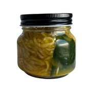 Jar of Living Lacto-Fermented Golden Beetroot with Kaffir Lime Leaf with a black lid on a white background