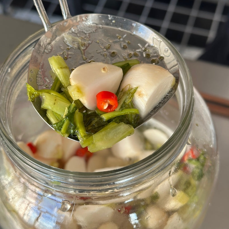 Spoonful of Living Lacto-Fermented Kabu Radish with Chili in a jar