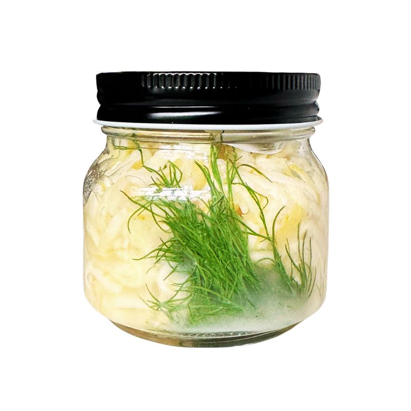 Jar of Living Lacto-Fermented Parsnip with a black lid on a white background