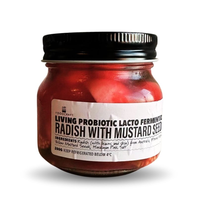 Jar of living probiotic lacto-fermented radish with mustard seed on a white background