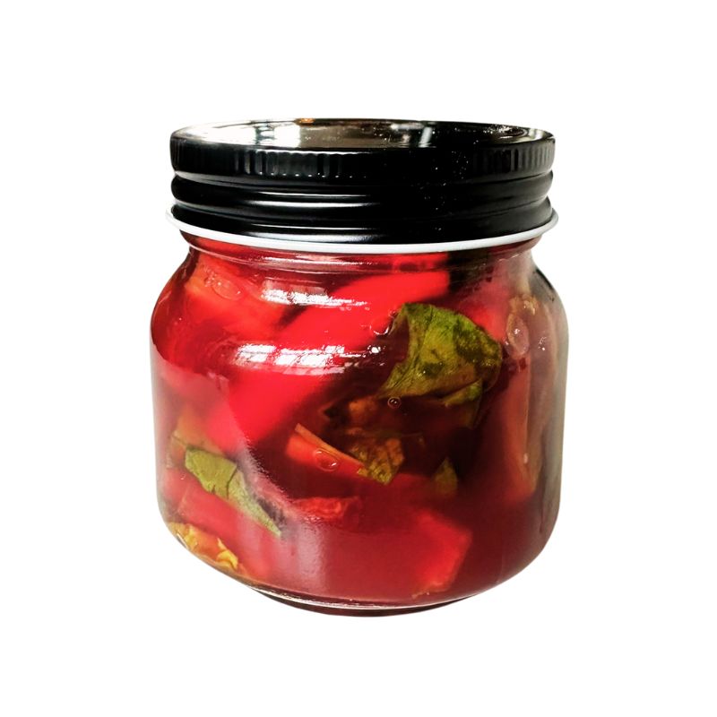 Jar of Living Lacto-Fermented Rainbow Chard with Chili with a black lid on a white background