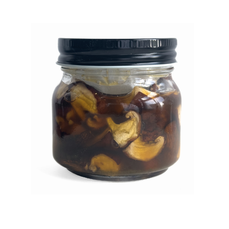 Jar of Living Lacto-Fermented Shiitake Mushrooms with a black lid on a white background