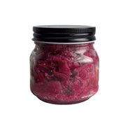 Jar of Living Lacto-Fermented Watermelon Radish Koji Zuke with a black lid on a white background