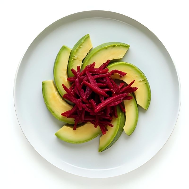 Avocado slices with Living Lacto-Fermented Beetroot on a white plate