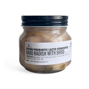 Jar of living probiotic lacto-fermented kabu radish with shiso on a white background