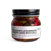 Jar of probiotic lacto-fermented rainbow chard with chili on a white background