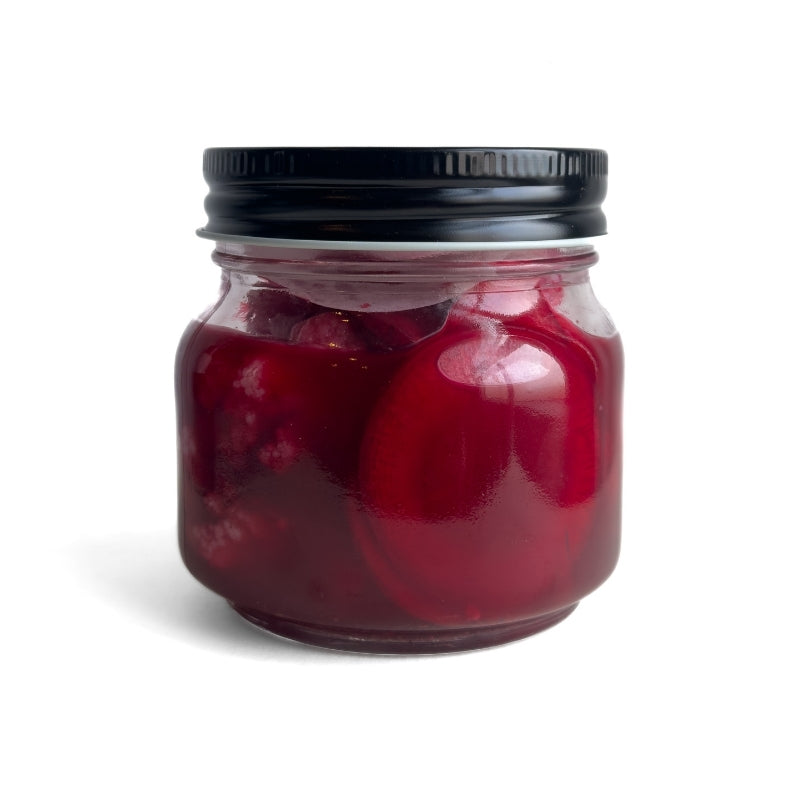 Jar of Living Lacto-Fermented Cauliflower & Purple Carrots with Sumac with a black lid on a white background