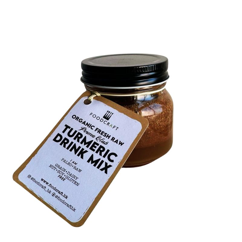 Jar of organic fresh raw turmeric drink mix with a label on a white background