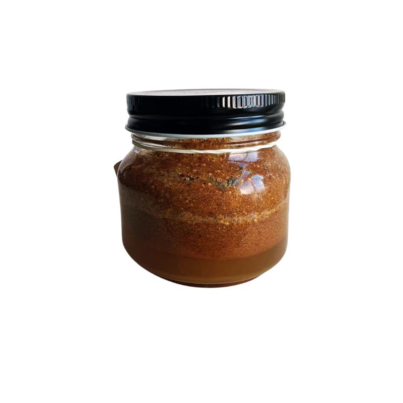 Jar of Organic Fresh Raw Turmeric Drink Mix with a black lid on a white background