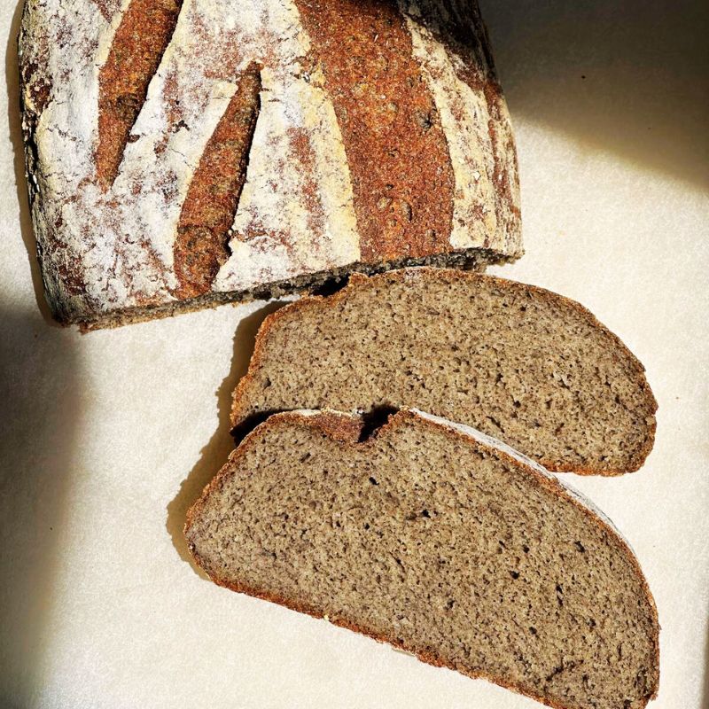 Loaf of Organic Gluten-Free Sourdough Bread (Xanthan Gum Free) - 1lb with two slices on a light background