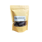 Bag of organic Medjool dates with a visible brand label on a white background