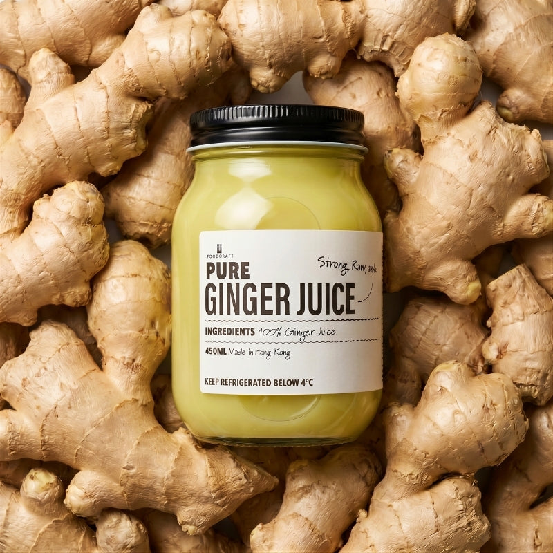 Jar of  Pure Ginger Juice - 450ml  surrounded by fresh ginger roots