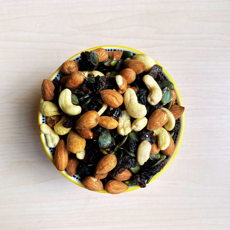 Raw Sprouted Classic Energy Trail Mix in a bowl on a light wooden surface
