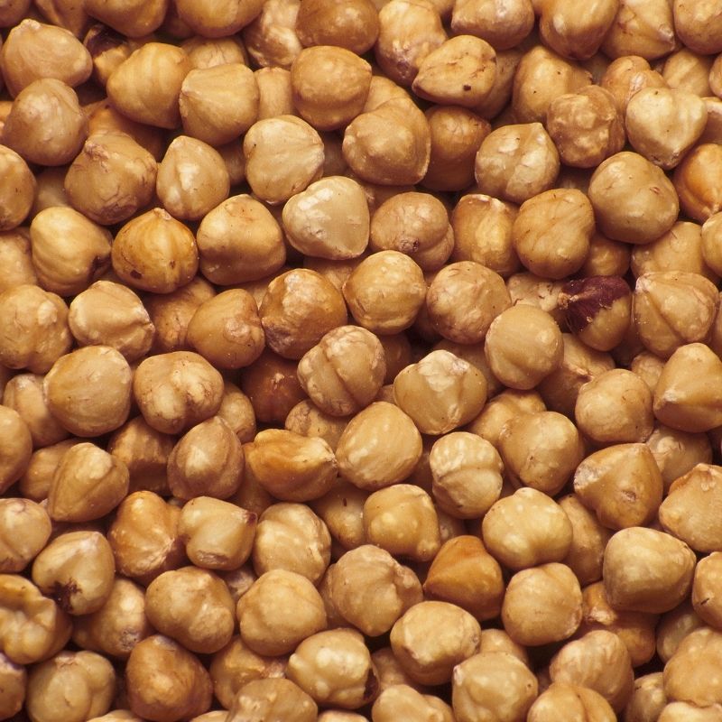 A close-up, top-down view of Raw Sprouted Hazelnuts - 400g filling the entire frame.