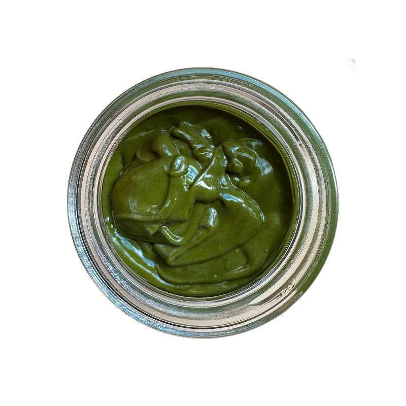 Jar of Raw Sprouted Pumpkin Seed Butter with a silver lid on a white background