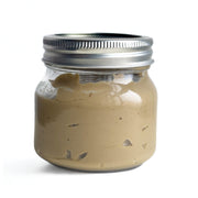 Jar of Raw Sprouted Sunflower Butter with a metal lid on a white background