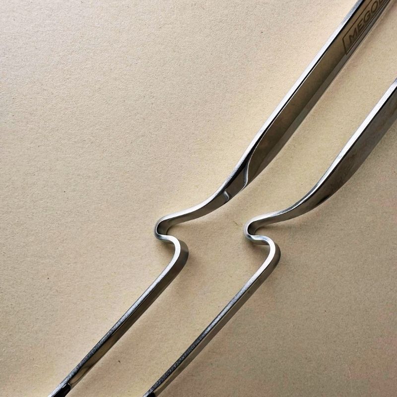 Stainless Steel Ladle and Strainer Pot Spoon Set on a beige background