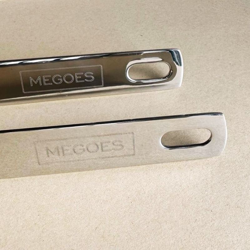 Stainless Steel Ladle and Strainer Pot Spoon Set with 'MEGOES' branding on a beige background
