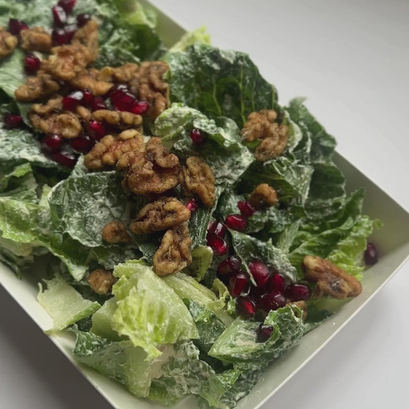 Load video: A close up video of Crispy Romaine Salad with Pomegranate, House Cashew Sour Cream &amp; Garlic-Herb Sprouted Walnuts