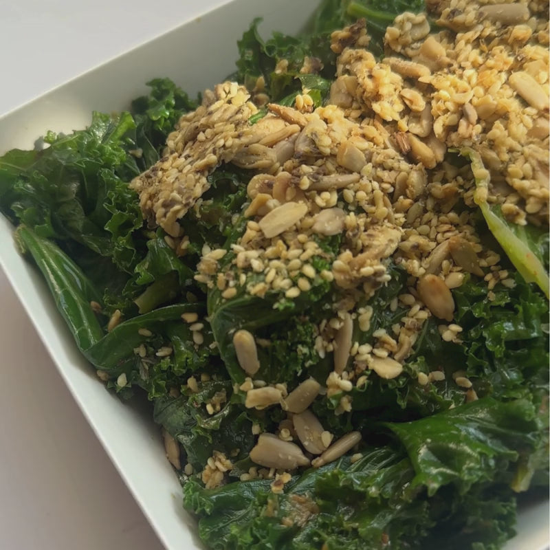 A close up of Kale Salad with Chilli Miso Dressing and Vegan Cheesy Seed Crunch Topper - (400g | Serves 4 – 6 people)